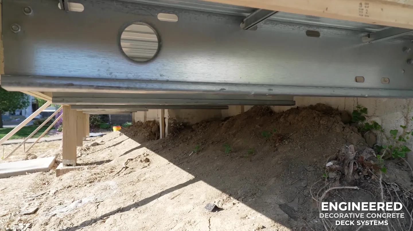 Steel beam and metal deck framing beneath a concrete deck system